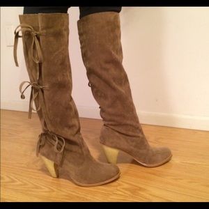 Tan faux suede boots with ties.